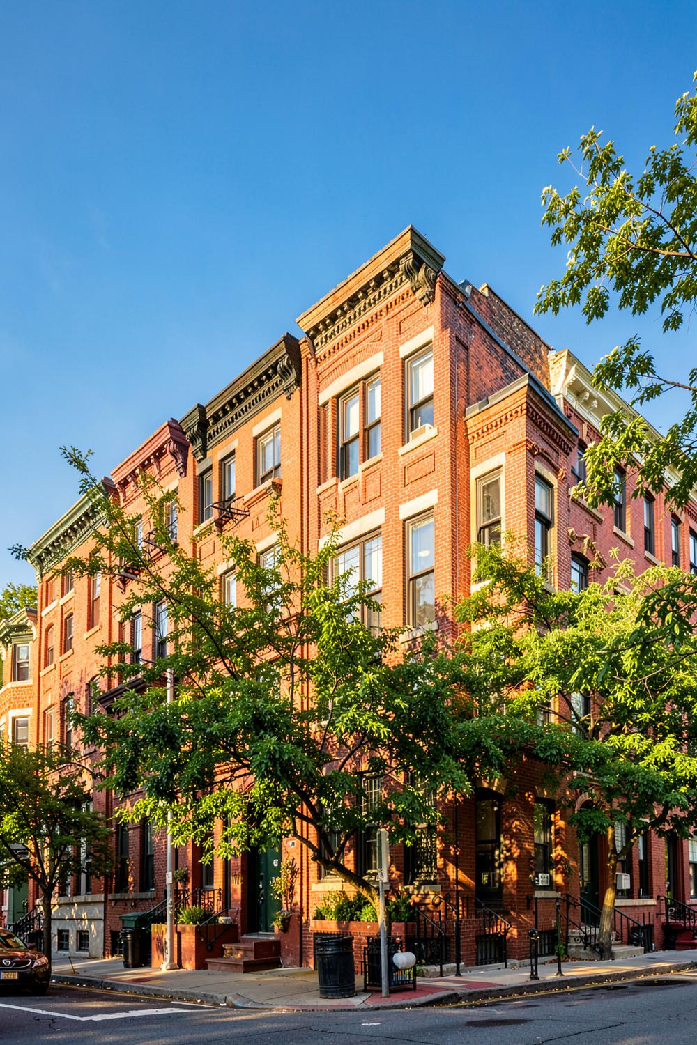 Sunlit row of Bronx brick townhouses